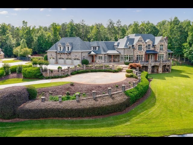 Stone estate home with a circular drive in North Fulton